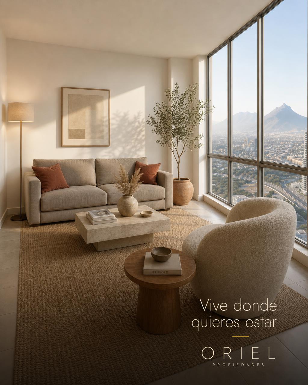 The apartment's living room from the opposite corner, with the large window and mountain view
